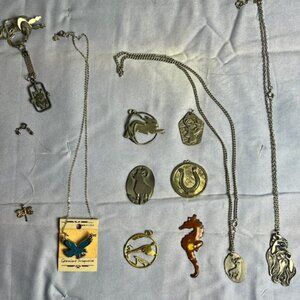 Collection of metal pendants, necklaces with various designs, vintage, collector